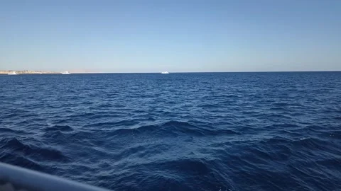 Deep Blue Sea Waves and Distant Yachts Stock Footage 330424664