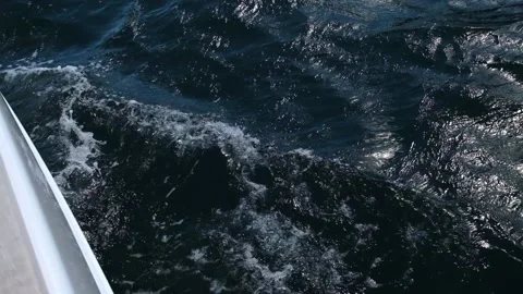 Deep blue sea waves run from sailing yacht on cold sunny day Stock Footage 168368745