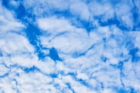 Deep blue sky with clouds below. Abstract background. Stock Photos