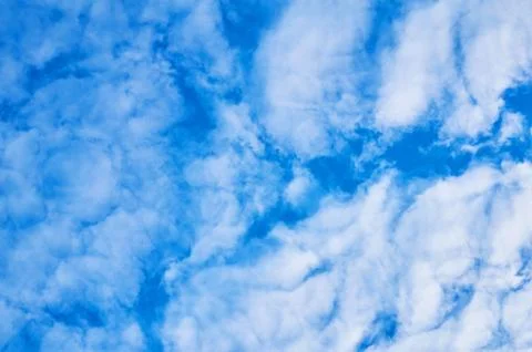 Deep blue sky with clouds below. Abstract background. Stock Photos