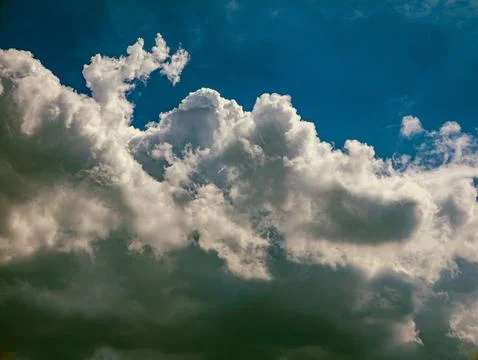 Deep Blue Sky with Dramatic White Cumulus Clouds, Vertical Nature Background Stock Photos