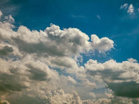 Deep Blue Sky with Dramatic White Cumulus Clouds, Vertical Nature Background Stock Photos