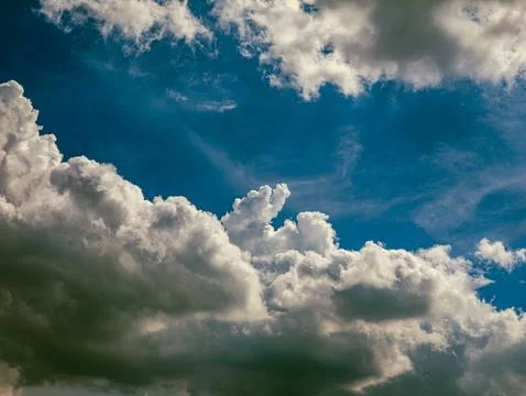 Deep Blue Sky with Dramatic White Cumulus Clouds, Vertical Nature Background Stock Photos