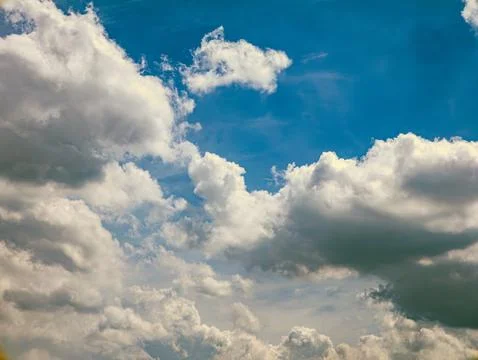 Deep Blue Sky with Dramatic White Cumulus Clouds, Vertical Nature Background Stock Photos