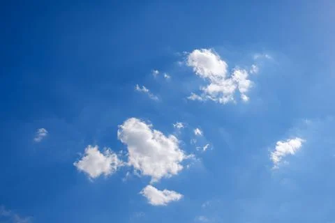 Deep blue sky with some white clouds Stock Photos