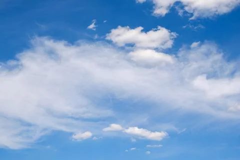 Deep blue sky with some white clouds Stock Photos