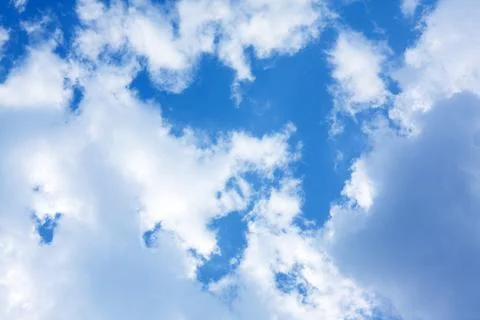 Deep blue sky with white clouds illuminated by sunlight texture Stock Photos