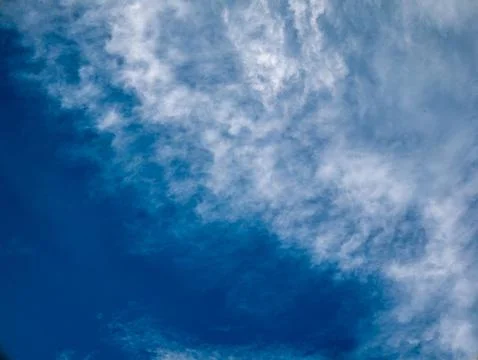 Deep Blue Sky with Wispy White Clouds Swirling Pattern, Horizontal Nature B.. Stock Photos