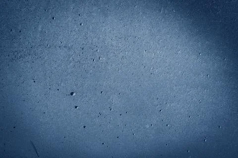 Deep blue textured wall surface with subtle rough patterns and light reflection Stock Photos