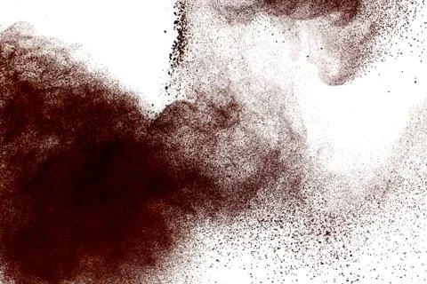 Deep brown powder dust explosion on white background. Stock Photos