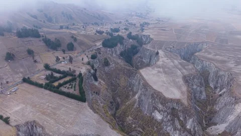 Deep canyon cutting through rugged Ecuador landscape, winding road, nestled 스톡 동영상 308401103