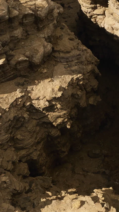 Deep canyon reveals rugged earth beneath blue sky on a sunny day Stock Footage 335096659