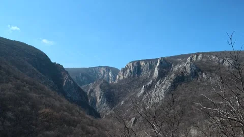 Deep canyon stretches beneath clear blue sky. Balkan, Eastern Europe, POV Video stock 331430655