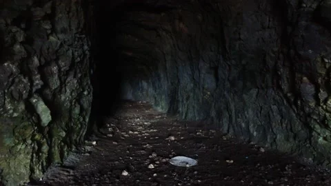 A deep cave in the heart of a mountain goes into darkness Stock Footage