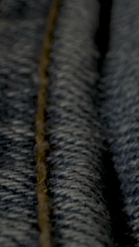 Deep Channels And Ridges Form Textured Patterns On Denim Material Stock Footage 335109155