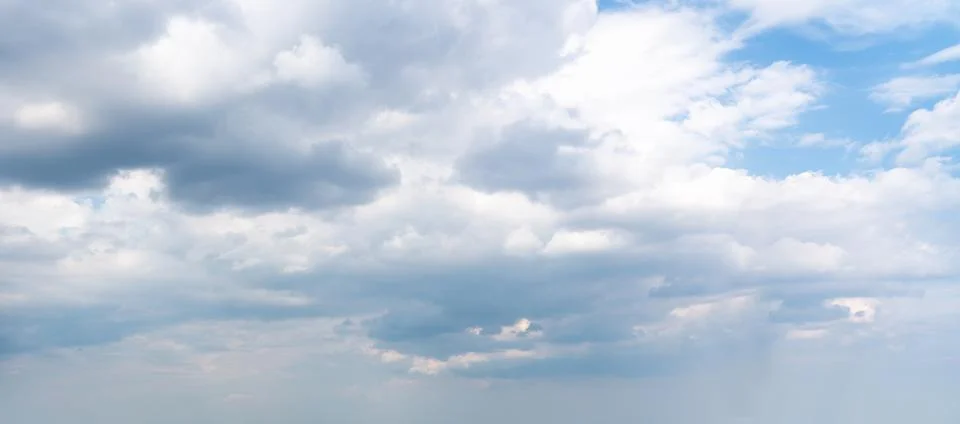Deep cloud layer of a beautiful blue sky with glimpses of the sun Stock Photos