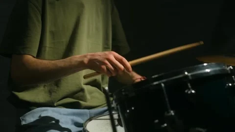 Deep concentration of a drummer in green t-shirt immersed in playing the drums Stock Footage 312846083