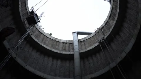 Deep construction shaft vertical walls lined with rough concrete as industrial l Stock Footage 309661926