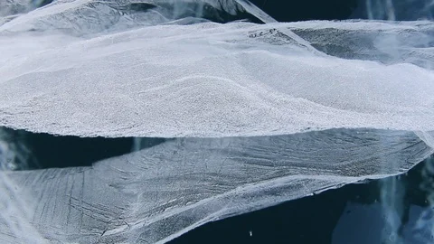 Deep crack in the blue transparent ice of Lake Baikal, Russia Siberia winter Stock Footage 126095337