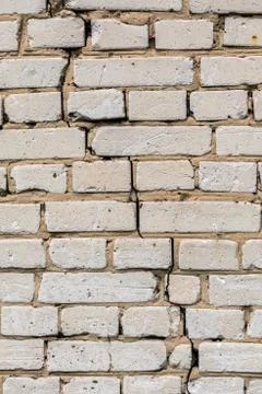 Deep cracked white silicate brick wall closeup texture and background Stock Photos