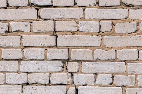 Deep cracked white silicate brick wall closeup texture and background Stock Photos