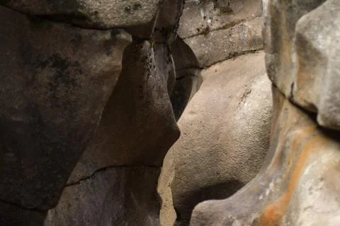 Deep crevice with smooth wave walls and elegant orange rock lichen Stock Photos