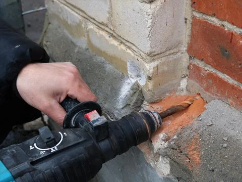 Deep drilling of the outer wall of the building Stock Photos