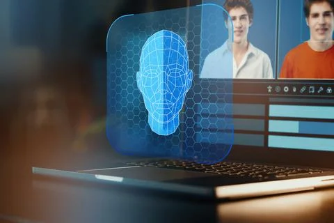 Deep fake technology displayed on a laptop with blue holographic face and 写真素材