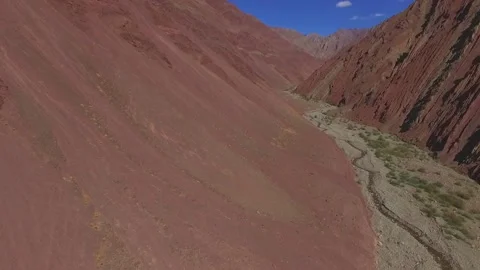 Deep fly over red stony harshcanyons in the Himalayas. Stock Footage 130393390