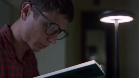 Deep focus and attention man reading a book after laptop work training Stock Footage 318966413