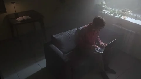 Deep focus and concentration at night, man working quietly on laptop in dark Stock Footage 318651713