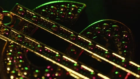 Deep focus of a dollar sign bling necklace in green, pink and purple. Stock Footage 245696752