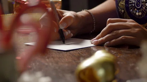 Deep Focus Shot From Candy Canes to a Woman Signing an Envelope Stock Footage 56641147