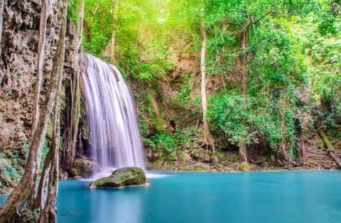 Deep forest waterfall at Erawan waterfall, beautiful waterfall with sunlight Stock Photos