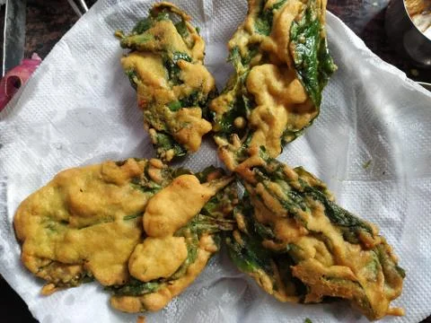 Deep fried and crispy chicken breast with green spinach Pakora. Stock Photos
