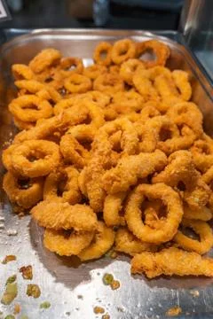 Deep fried batter squid rings on the tray for sale Stock Photos