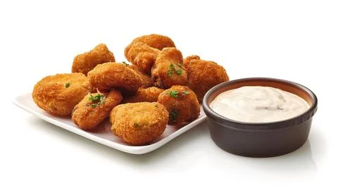 Deep fried battered mushroom caps served in a basket with side of ranch dre.. Stock Photos