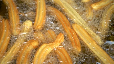 Deep-fried biscuits. Sweets fried in vegetable oil. Confectioner makes pastry. Stock-Footage 107640585