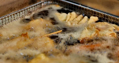 Deep fried in boiling oil and wire basket. Stock Footage 119133468