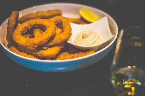 Deep fried breaded Calamari served with Garlic Aioli in a white dish Stock Photos