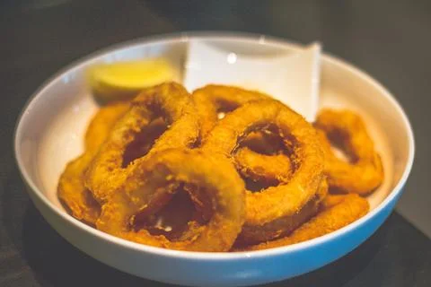 Deep fried breaded Calamari served with Garlic Aioli in a white dish Stock Photos