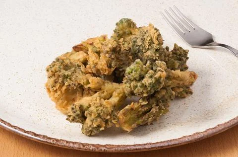 Deep-fried broccoli on a plate. close up Stock Photos