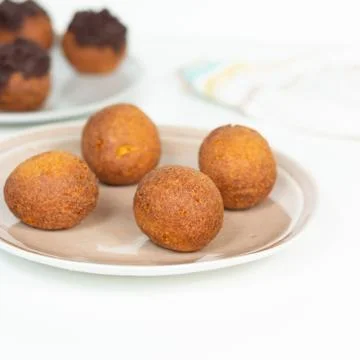 Deep fried bunuelos balls. Creative minimalist composition on a white background Stock Photos