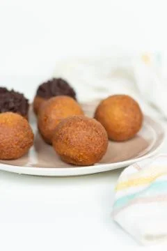 Deep fried bunuelos balls. Creative minimalist composition on a white background Stock Photos