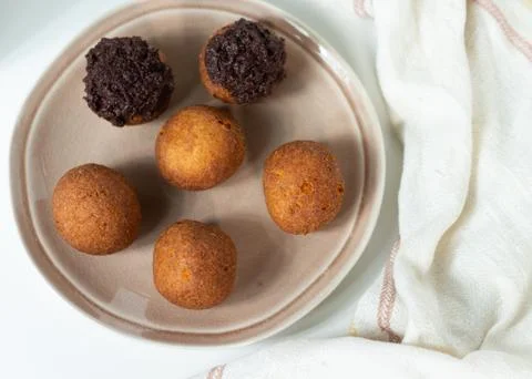 Deep fried bunuelos balls. Creative minimalist composition on a white background Stock Photos