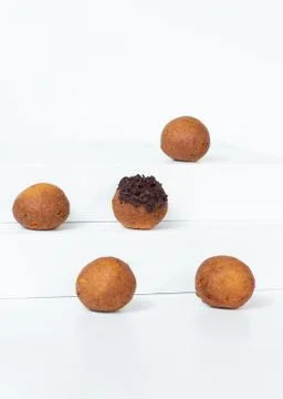 Deep fried bunuelos balls. Creative minimalist composition on a white background Stock Photos