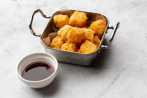 Deep fried Cheese squares served with cranberry sauce. Delicious homemade app Stock Photos