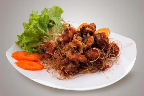 Deep fried chicken meat with dried lemongrass Stock Photos