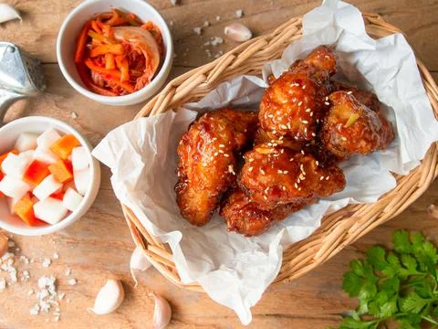 Deep fried chicken wing with garlic sauce in Korean style. Stock Photos