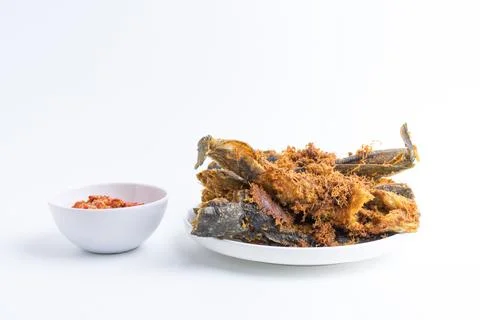 Deep fried crispy catfish served with spicy red chili paste sambal isolated.. Stock Photos